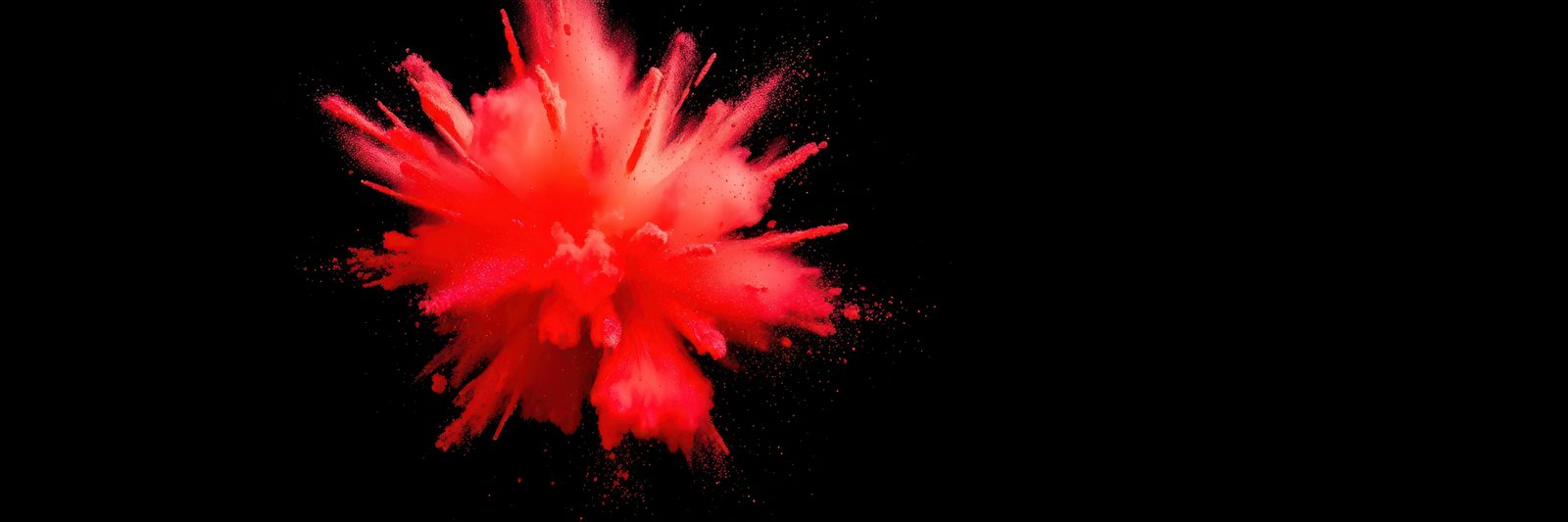 A red powder explosion against a black background